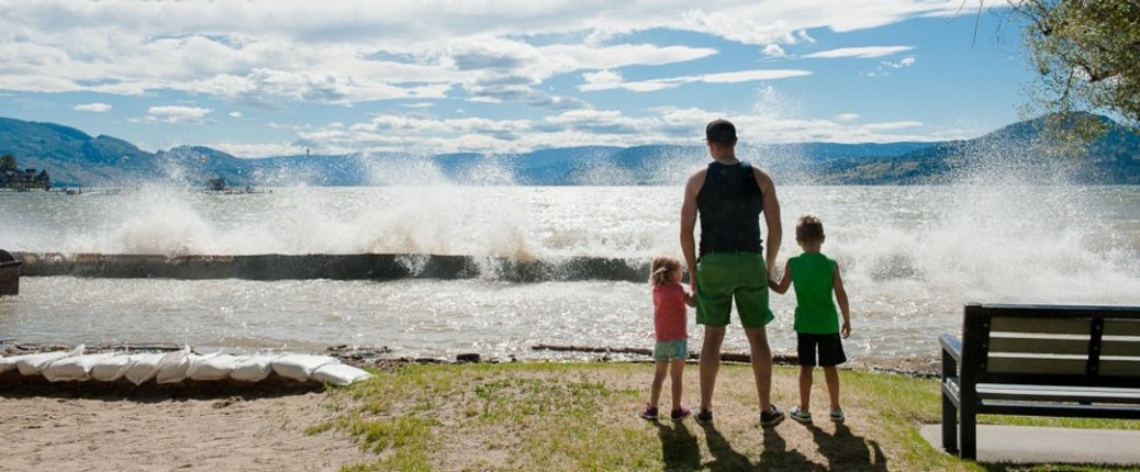 Father and two kids standing in front of Okanagan Lake
