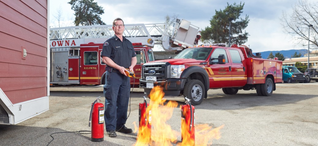 Fireman testing equipment near fire